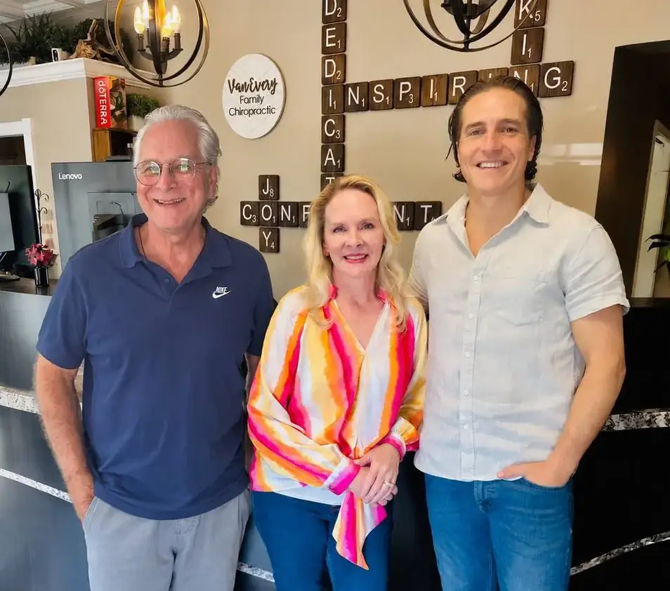Dr. John Johr, Dr. Anna Saylor and Dr. Zach Conner smiling together at the Van Every front desk